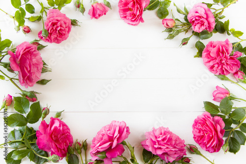 Fototapeta Naklejka Na Ścianę i Meble -  Pink Roses flat lay, floral composition on white wooden board, empty space for  text, concept for Wedding , St. Valentine's Day, Mother's Day, Birthday, 8 march, women's day, mock up design