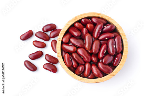 Closeup red kidney beans in wooden bowl isolated on white background with clipping path. Top view. Flat lay.