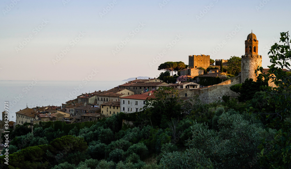 Skyline of Castiglione della Pescaia, a small medieval town in Tuscany, on the sea, at sunset