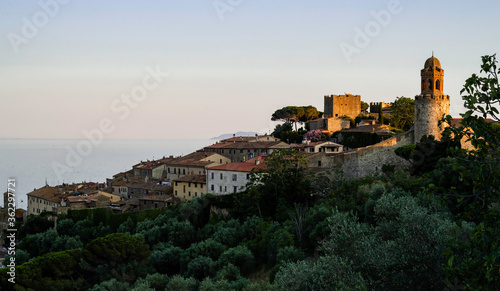 Skyline of Castiglione della Pescaia, a small medieval town in Tuscany, on the sea, at sunset photo