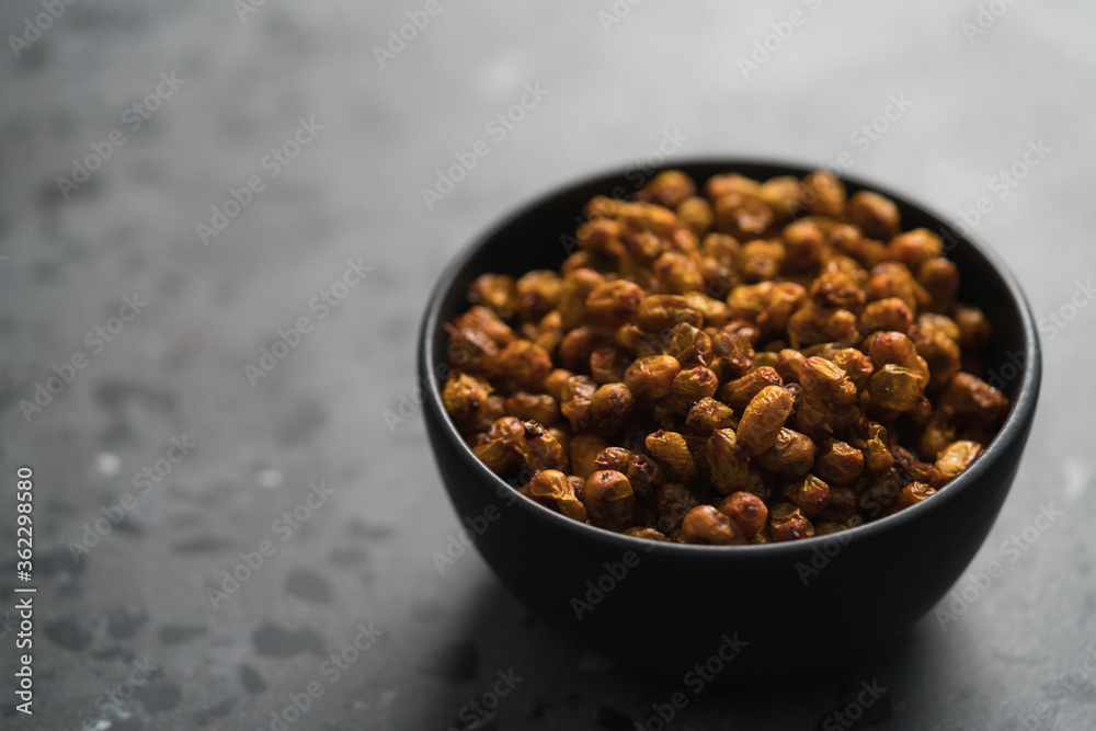 dried seaberry buckthorn in black bowl on terrazzo countertop with copy space dried seaberry buckthorn in black bowl on terrazzo countertop with copy space