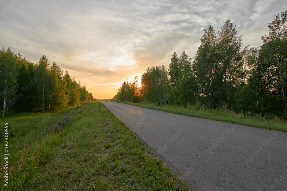 Fototapeta premium Country road during sunset.