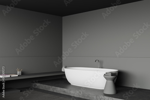 Grey bathroom corner with tub and shelf