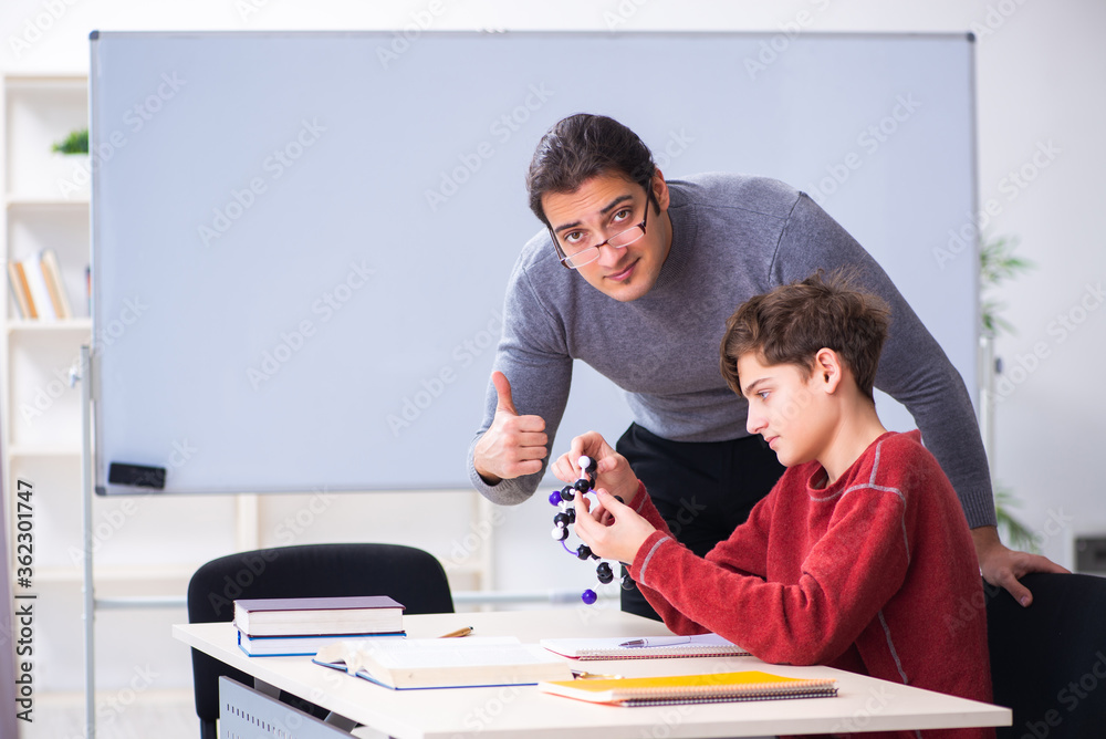 Young male teacher and schoolboy in the classroom Young male teacher and schoolboy in the classroom