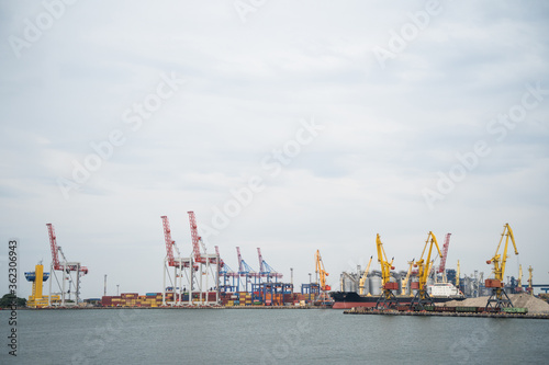 seaport where large containers are loaded on cargo ships © Tsyb Oleh