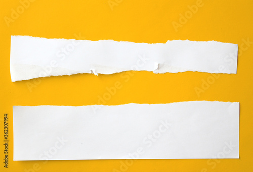 Ripped paper on yellow background.
