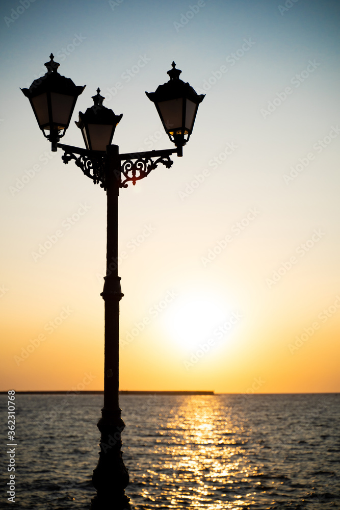 beautiful photo of a lantern at sunset on the sea