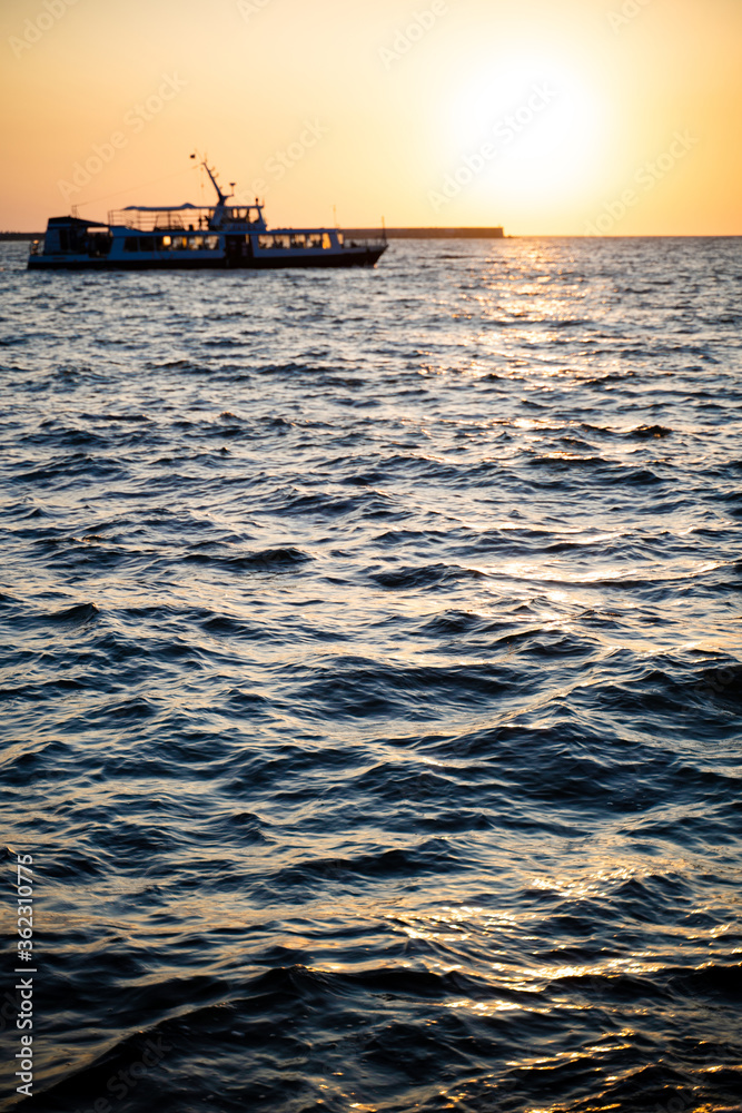 beautiful photo of a ship at sunset at sea