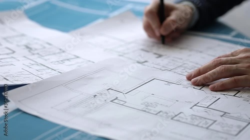 An architect makes notes on construction drawings photo