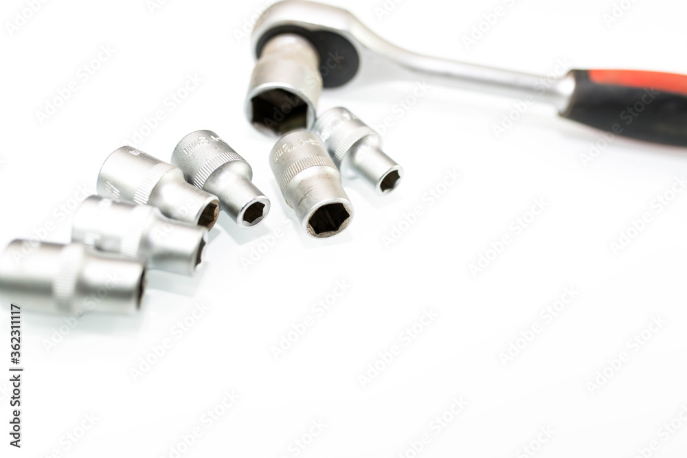 Used rachet wrench with sockets on white background with copy space. Used rachet wrench with sockets on white background with copy space.