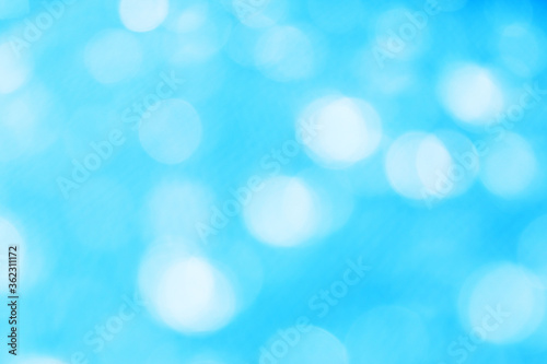clear white bokeh blur abstract background from photo of water drop on blue plastic net.