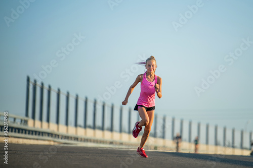 Girl runs on a sunny summer evening
