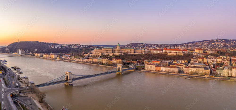 Panoramic aerial drone shot of chain bridge over danube river Buda castle before Budapest sunrise