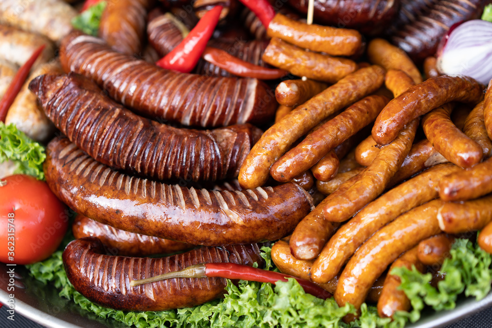 delicious grilled sausages with salad and vegetables delicious grilled sausages with salad and vegetables