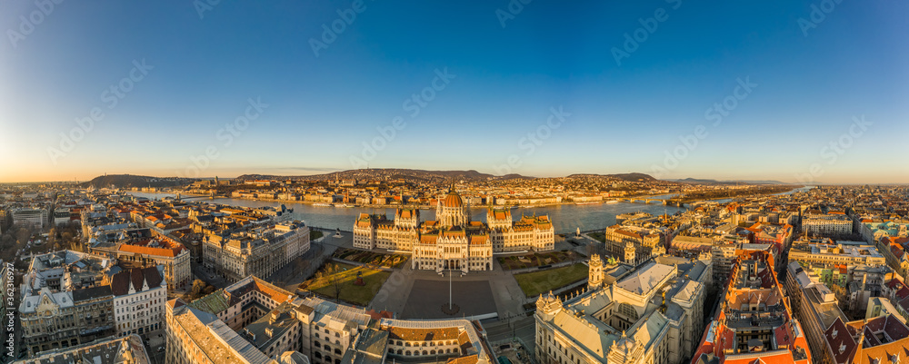 Panoramic Aerial drone shot of east side facade of Hungarian Parliament Kossuth Square during Budapest sunrise