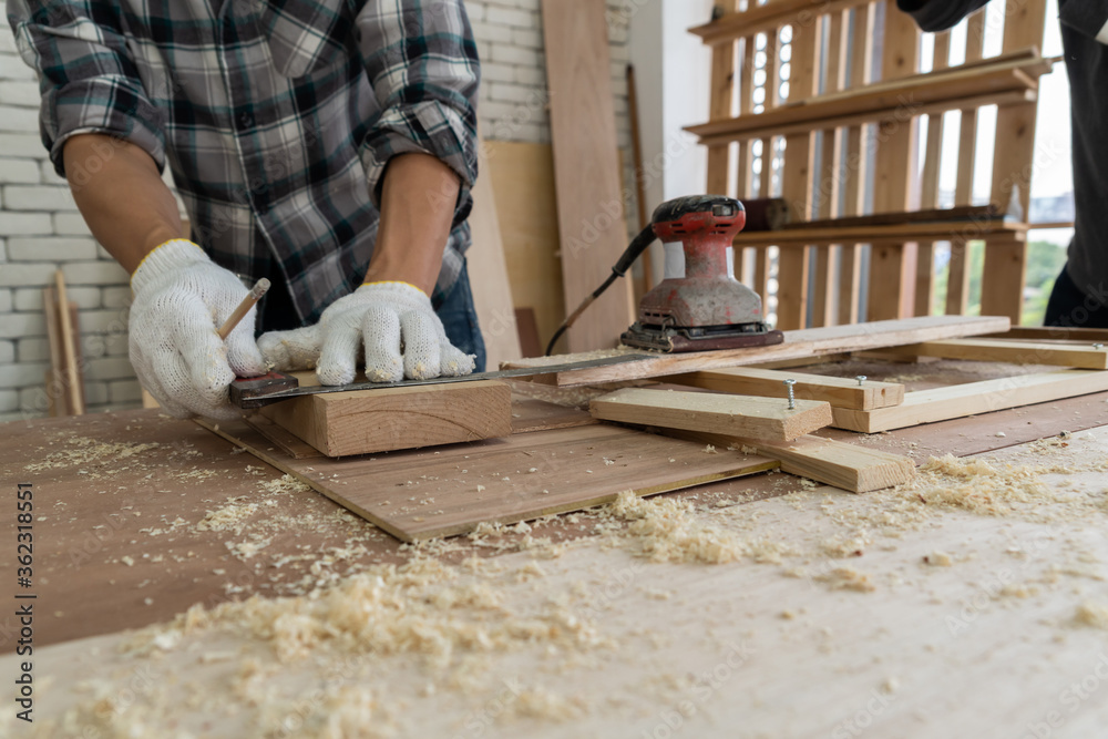 Carpenter working on wood craft at workshop to produce construction ...