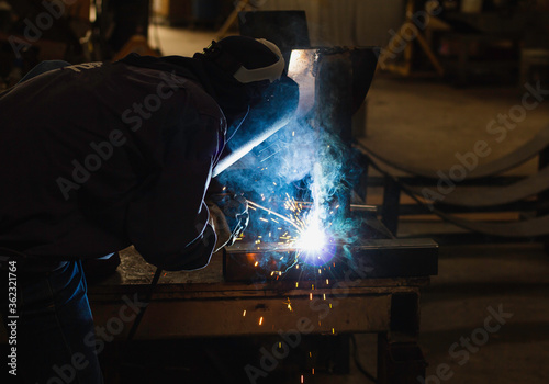 Metal workers use manual labor. Skilled welder. Factory workers making OT. Welder is welding the steel in the factory. welder Industrial automotive part in factory.