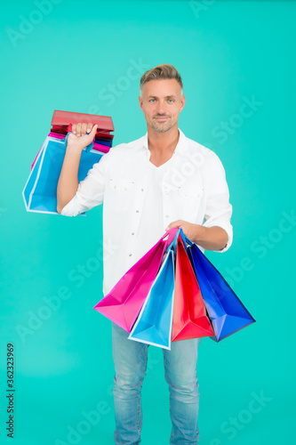 Handsome buyer. Free shipping. Mature man hold shopping bags. Cyber monday sale. Retail concept. Happy holidays. Seasonal sale. Hipster buying sale price. Birthday gift. Bachelor day. Black Friday