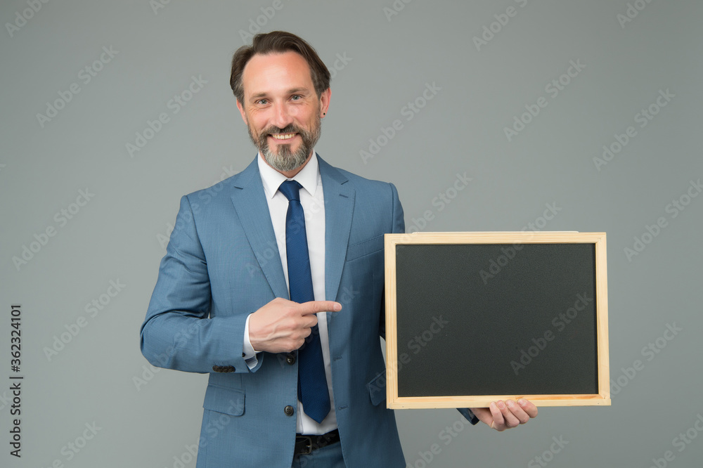 For sale. Happy boss pointing at school blackboard. Ad man with pointing gesture. Index finger pointing. Pointing for advertising. Information for promoting. Business marketing, copy space