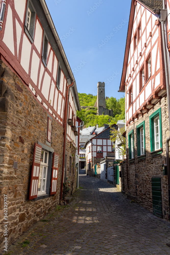 Narrow paved road in Monreal with Löwenburg in the background Narrow paved road in Monreal with Löwenburg in the background