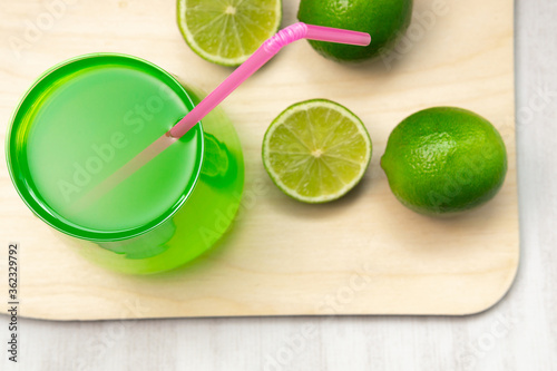Lemonade glasses with lime, wooden Board on a black background. Refreshing summer drink - detox cocktail