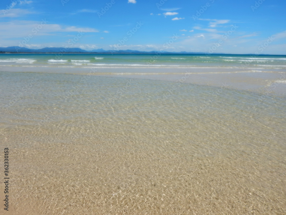 Tranquil beach scene. Calm inviting waters.