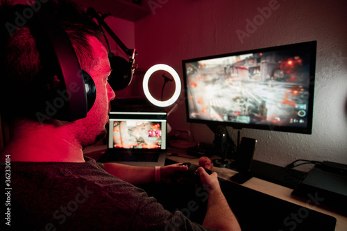 a gamer playing and streaming live with microphones and cameras