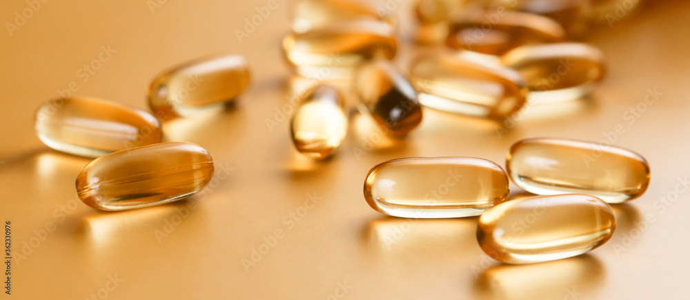 Many capsules Omega 3 on yellow background. Close up, high resolution product. Health care concept. Many capsules Omega 3 on yellow background. Close up, high resolution product. Health care concept.