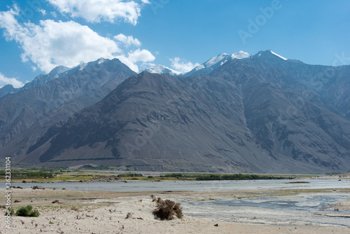 Afghanistan and Panj river at Wakhan Valley View from Zugvand Village, Gorno-Badakhshan, Tajikistan. It is located in the Tajikistan and Afghanistan border. photo