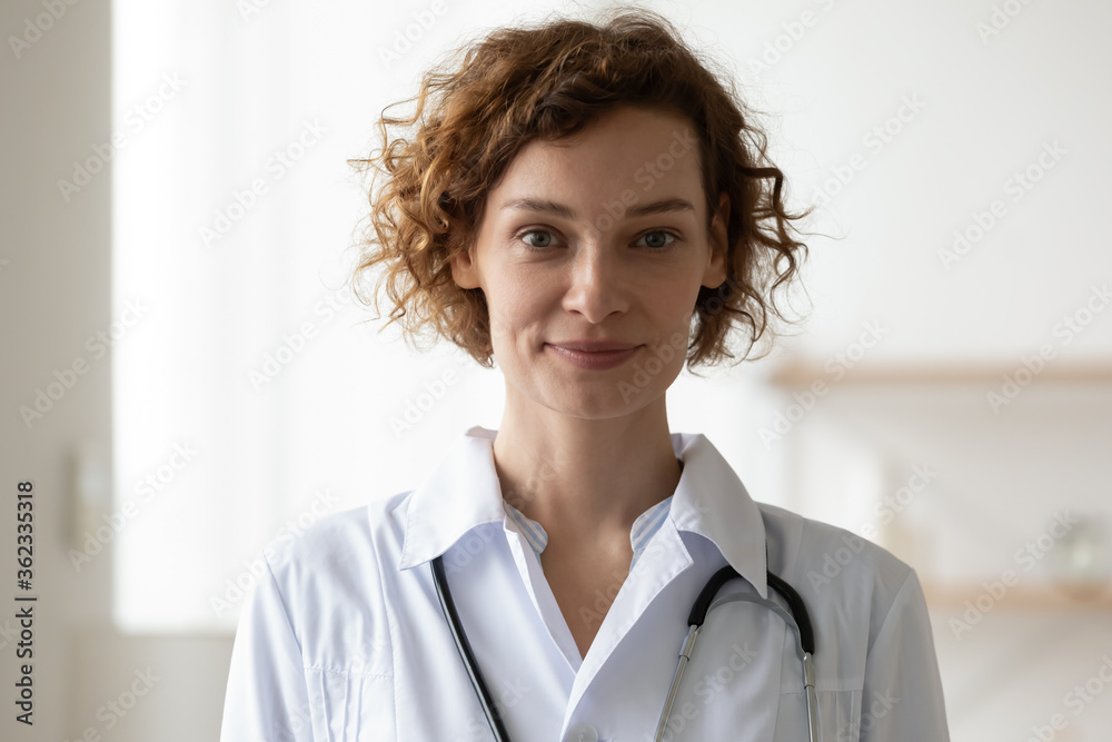 Profile picture of young Caucasian woman doctor or GP in white medical uniform look at camera in hospital posing, headshot portrait of smiling female nurse or physician show confidence professionalism Profile picture of young Caucasian woman doctor or GP in white medical uniform look at camera in hospital posing, headshot portrait of smiling female nurse or physician show confidence professionalism