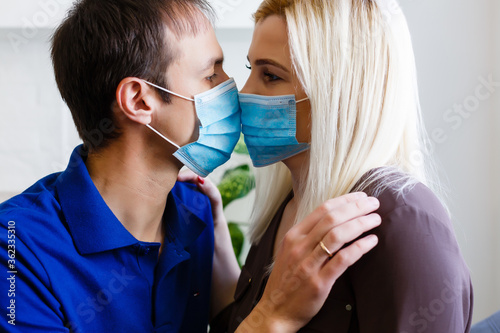 Couple in love, man and woman in protective medical mask on face. quarantine concept. Guy, girl against world pandemic coronavirus, virus protection