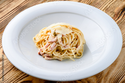 Italian pasta in a plate on a wooden table