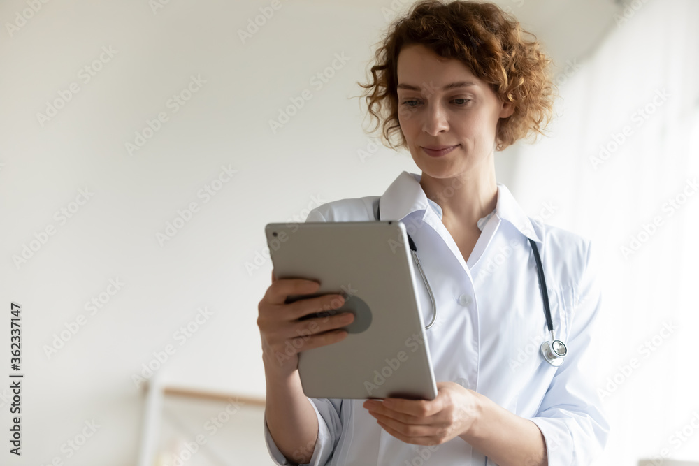Young Caucasian woman doctor in white medical uniform have video call online webcam conference on tablet, female nurse or GP use pad gadget consult clinic patient on internet, technology concept Young Caucasian woman doctor in white medical uniform have video call online webcam conference on tablet, female nurse or GP use pad gadget consult clinic patient on internet, technology concept