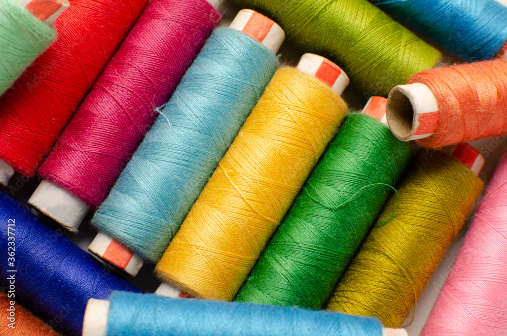 Multicolor sewing thread roll background Multicolor sewing thread roll background