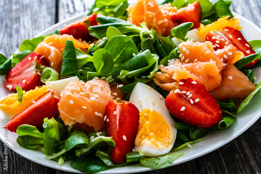 Salmon salad - smoked salmon boiled egg and vegetables on wooden background
Salmon salad - smoked salmon boiled egg and vegetables on wooden background