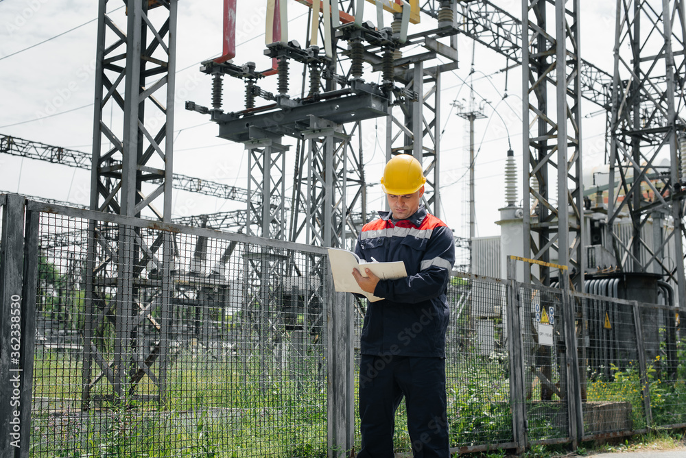 The energy engineer inspects the equipment of the substation. Power engineering. Industry. The energy engineer inspects the equipment of the substation. Power engineering. Industry.