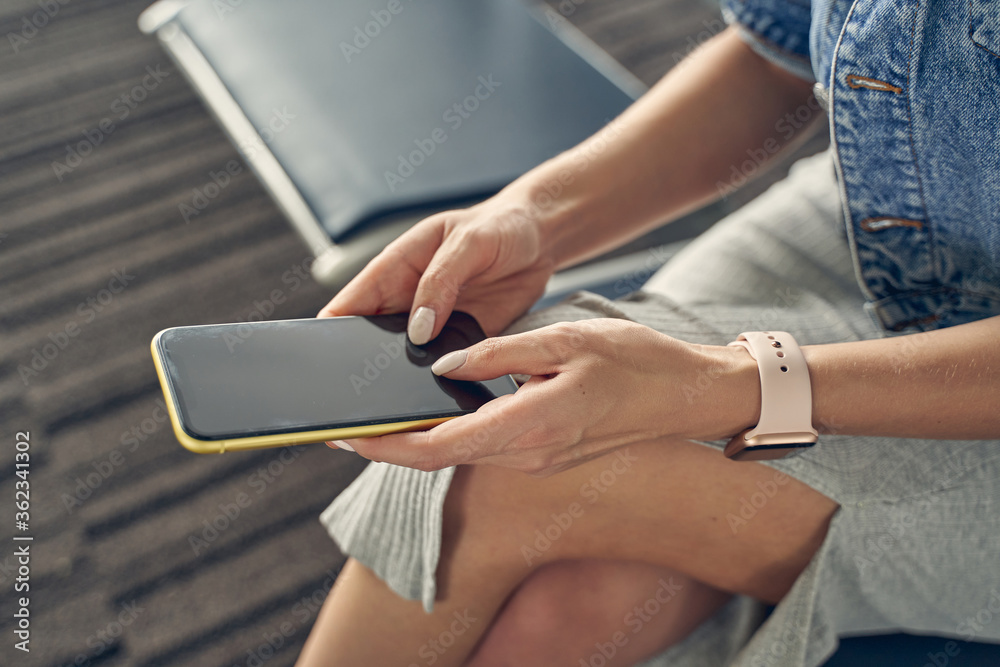 Close up of female person holding her smartphone