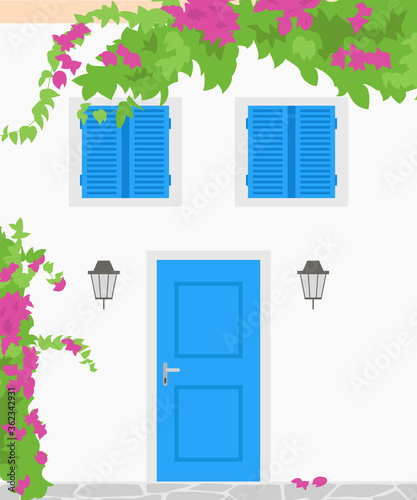 Traditional greek house with blooming flowers. Tourism concept.