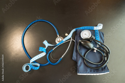 Blue stethoscope with tape measure. Pressure concept
