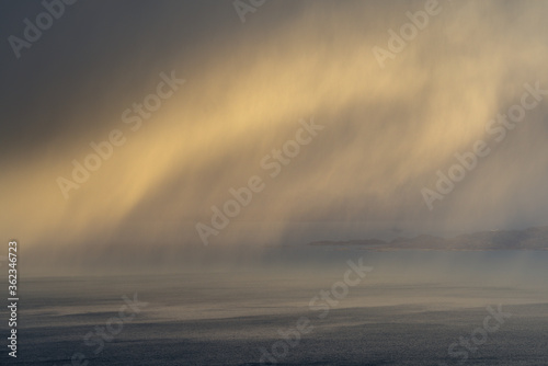 Passing rain shower on the Inner Hebrides Scottish Coast. Fine art abstract background with subtle dark and light tones giving a painterly feel.