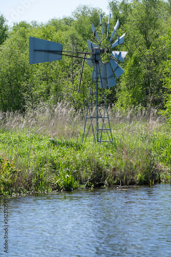 Windmill in the dutch nature reserve Rottige Meenthe in the Netherlands to keep the reed land wet. photo