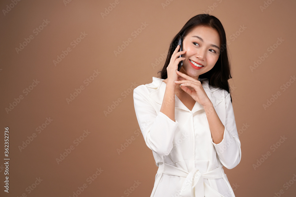 Asian business woman recommended smartphone apps for internet marketing, Business casual outfit, isolated with mocha brown background