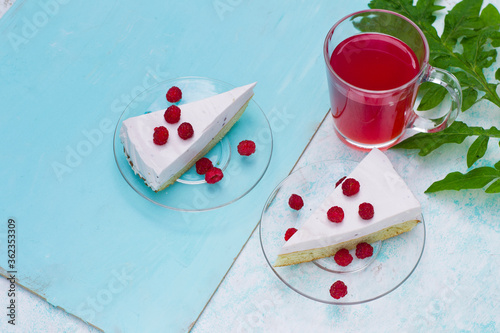 A slice of homemade berry cheesecake garnished with raspberries. Healthy delicious vegetarian dessert.