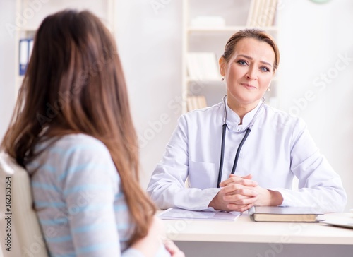 Pregnant woman visiting doctor for regular check-up