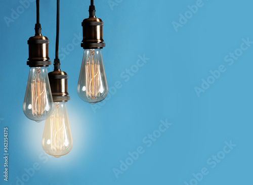 Idea concept. Light bulbs on blue background, space for text