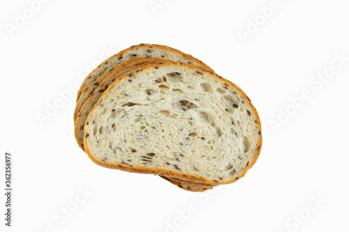 The cut loaf of bread with seeds isolated on grey background. Close up food photo.