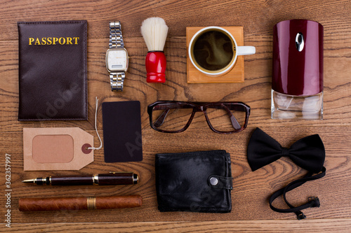 Accessories of a rich old man. Topview flat lay. Brown wooden surface.