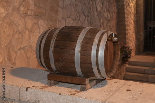 A wine  barrel stands in the evening as a decorative ornament in the Jerusalem Mishkenot Sheananim - Hutzot Hayotzer quarter in Jerusalem, Israel