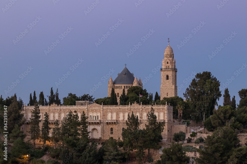 View from the Jerusalem Mishkenot Sheananim - Hutzot Hayotzer quarter to the Dormition Abbey in the light of the rays of the setting sun in Jerusalem, Israel