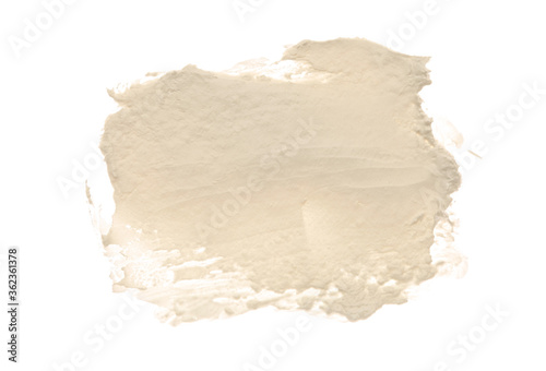 Abstract acrylic beige color smear brush stroke. Isolated on white background.